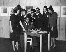 Frank Marshall Davis signing copies of his poetry collection. 