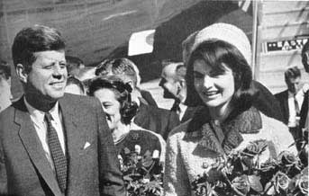 Mrs. Kennedy is presented with a bouquet of RED Roses!!