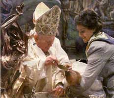 Pope John Paul baptizing an infant. 